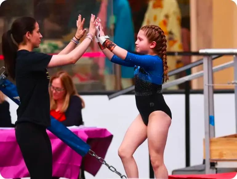 Freehold Elite Gymnastics coach and athlete high-fiving
