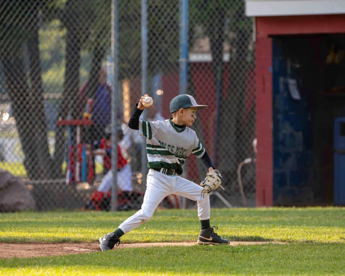 Youth little league pitcher throwing a pitch